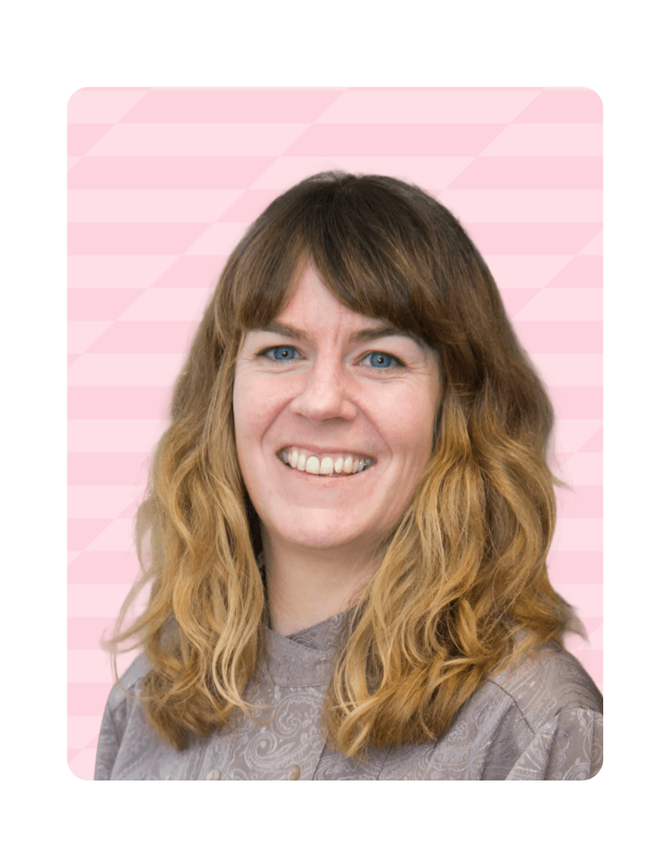 Two men shaking hands during a social interaction, one wearing a blue and green patterned scarf and glasses.