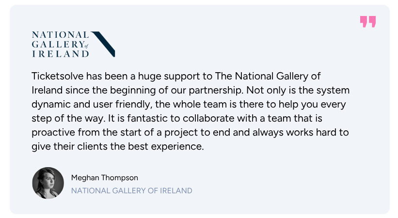 Man with tied-back hair and star tattoo on neck speaking at a microphone while using a laptop on a stand.