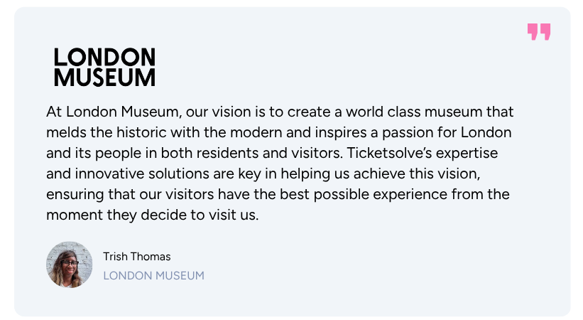 Four women seated on stage chairs engaged in a panel discussion, with one woman speaking into a microphone and a Ticketsales banner in the background.