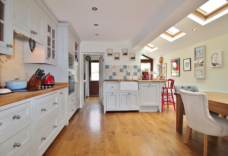 The modern kitchen extension maintains the period house atmosphere