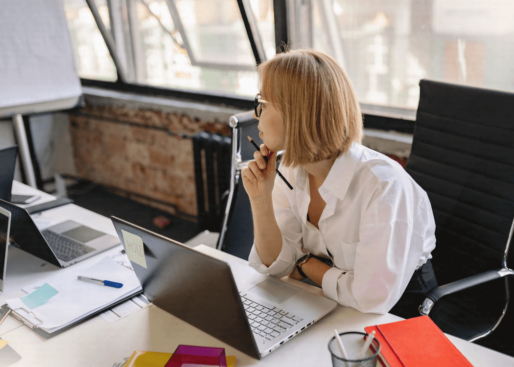 Woman sitting at her desk thinking about something. 
