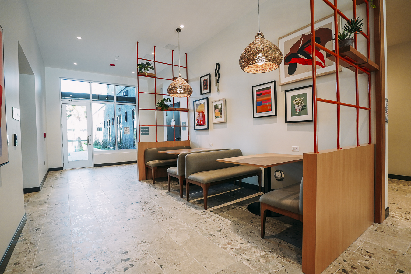 Resident amenity space featuring a stylish, speckled terrazzo coffee bar area with baked goods and green accent seating at ArtHaus Telegraph in Berkeley, CA.