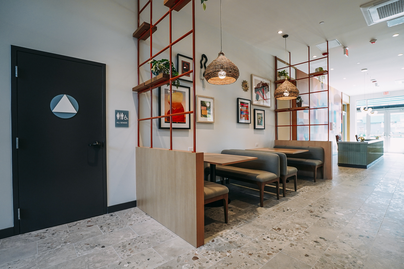 Resident amenity space featuring a stylish, speckled terrazzo coffee bar area with baked goods and green accent seating at ArtHaus Telegraph in Berkeley, CA.