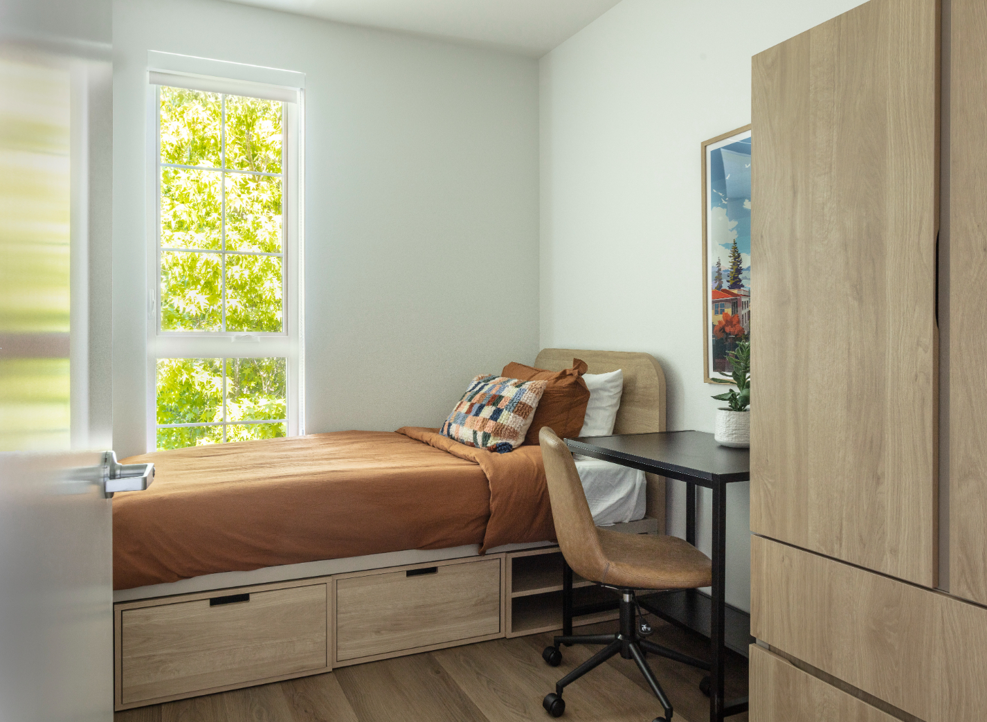 Furnished modern Studio apartment with bed, desk with chair, and kitchen 