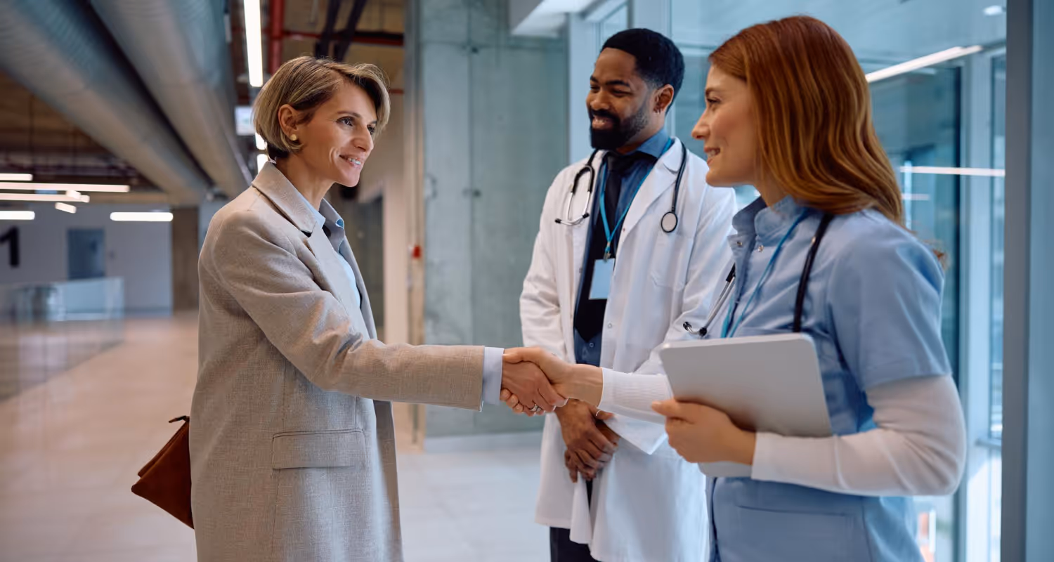 Concierge doctor in Great Neck, NY, greeting a patient at a modern medical office for personalized healthcare services.