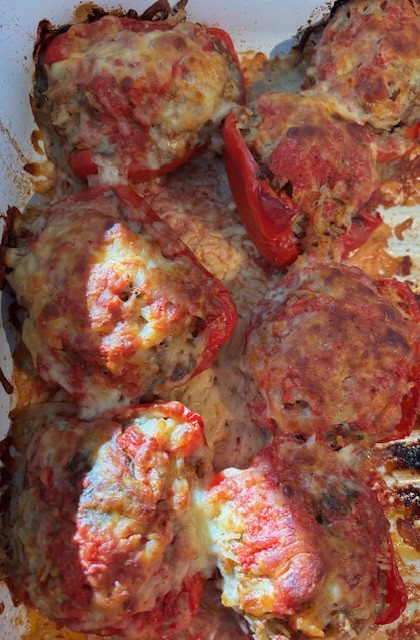 Burger with fried fries on black plate with sauce on the side