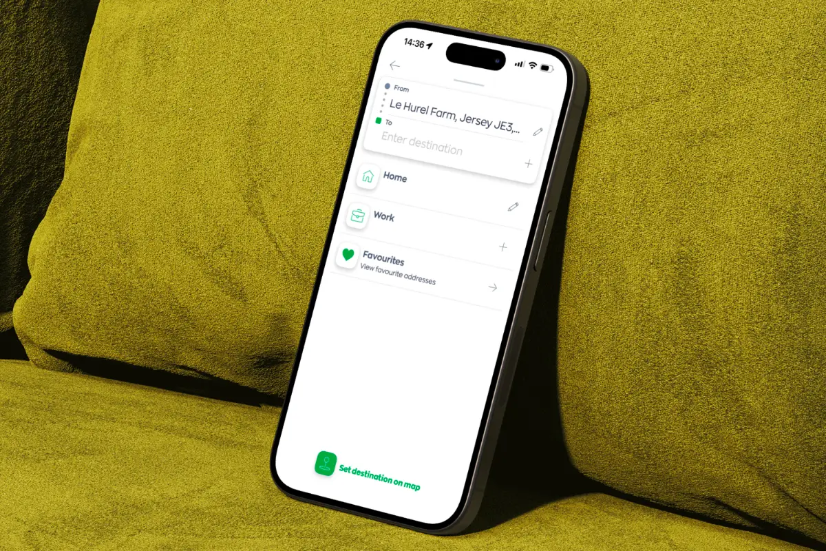 Smartphone displaying a navigation app with 'From' location set to Le Hurel Farm, Jersey, and options for Home, Work, and Favourites addresses.