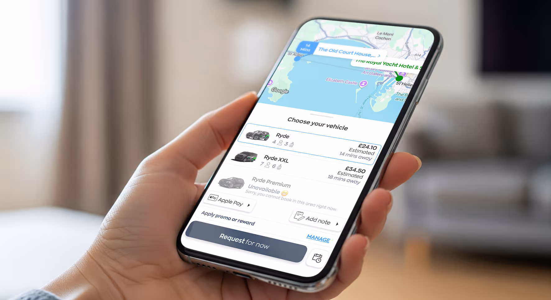 Hand holding phone displaying ride-hailing app with vehicle options and prices on screen.
