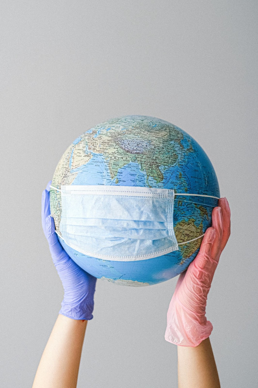 A globe wearing a mask to demonstrate communications that were disrupted during COVID19.