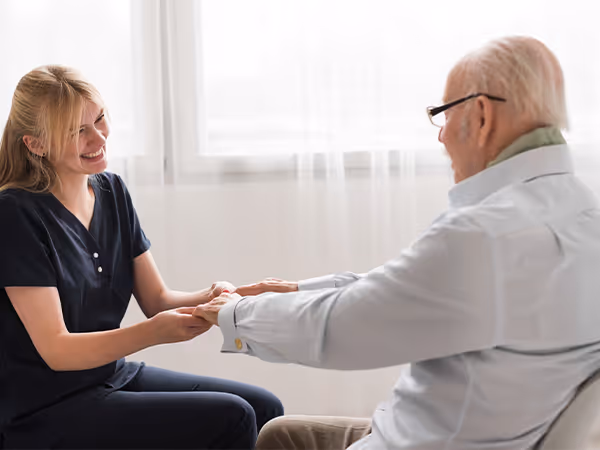young doctor holding hands with an elderly patient. 