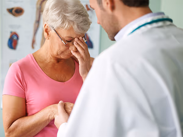 a woman being helped by a doctor for dizziness