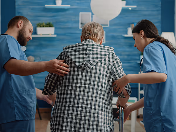 doctors helping a patient walk