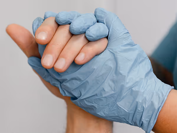 a doctor holding a patients hand