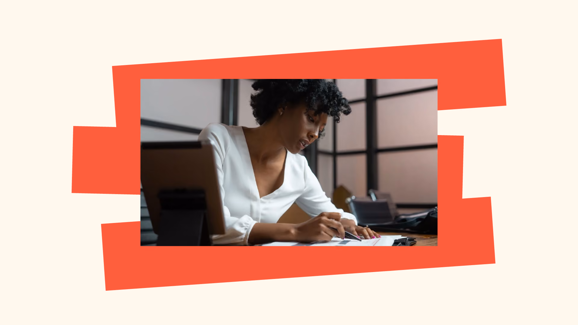 Woman with curly hair and white blouse seated at a desk, writing on paper with a pen. Image is framed by bold orange and cream graphics.
