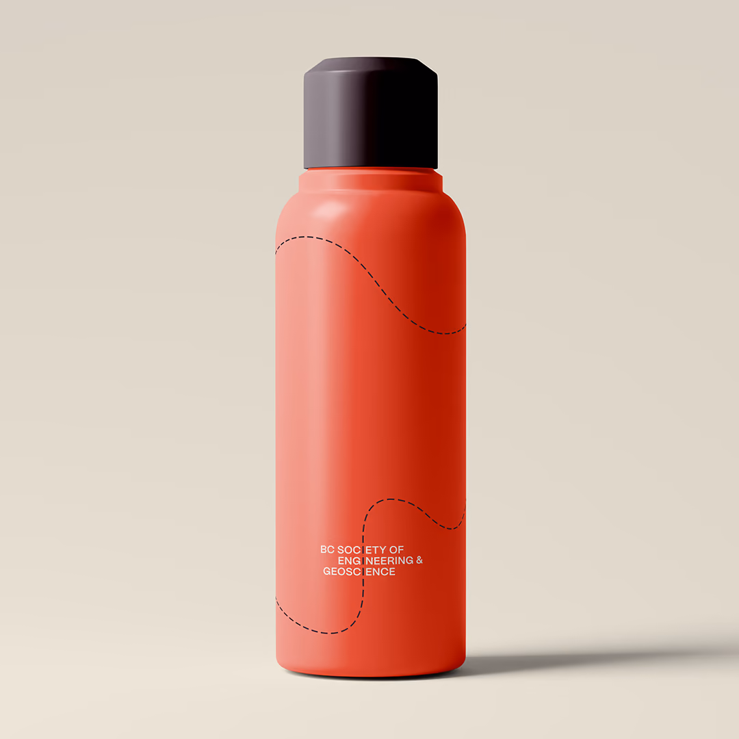 Red water bottle with black cap standing against a beige background, featuring black dashed contour lines and white logo reading 'BC SOCIETY OF ENGINEERING & GEOSCIENCE.'