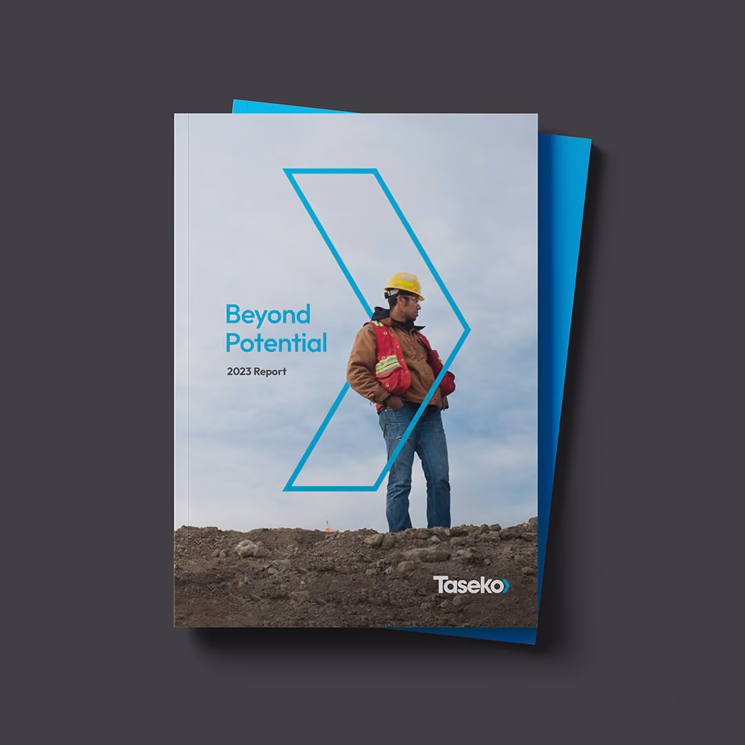 Cover of a 2023 report titled 'Beyond Potential' by Taseko showing a construction worker wearing a yellow hard hat, red safety vest, brown jacket, and jeans standing on rocky ground against a cloudy sky, framed within a blue angular outline.