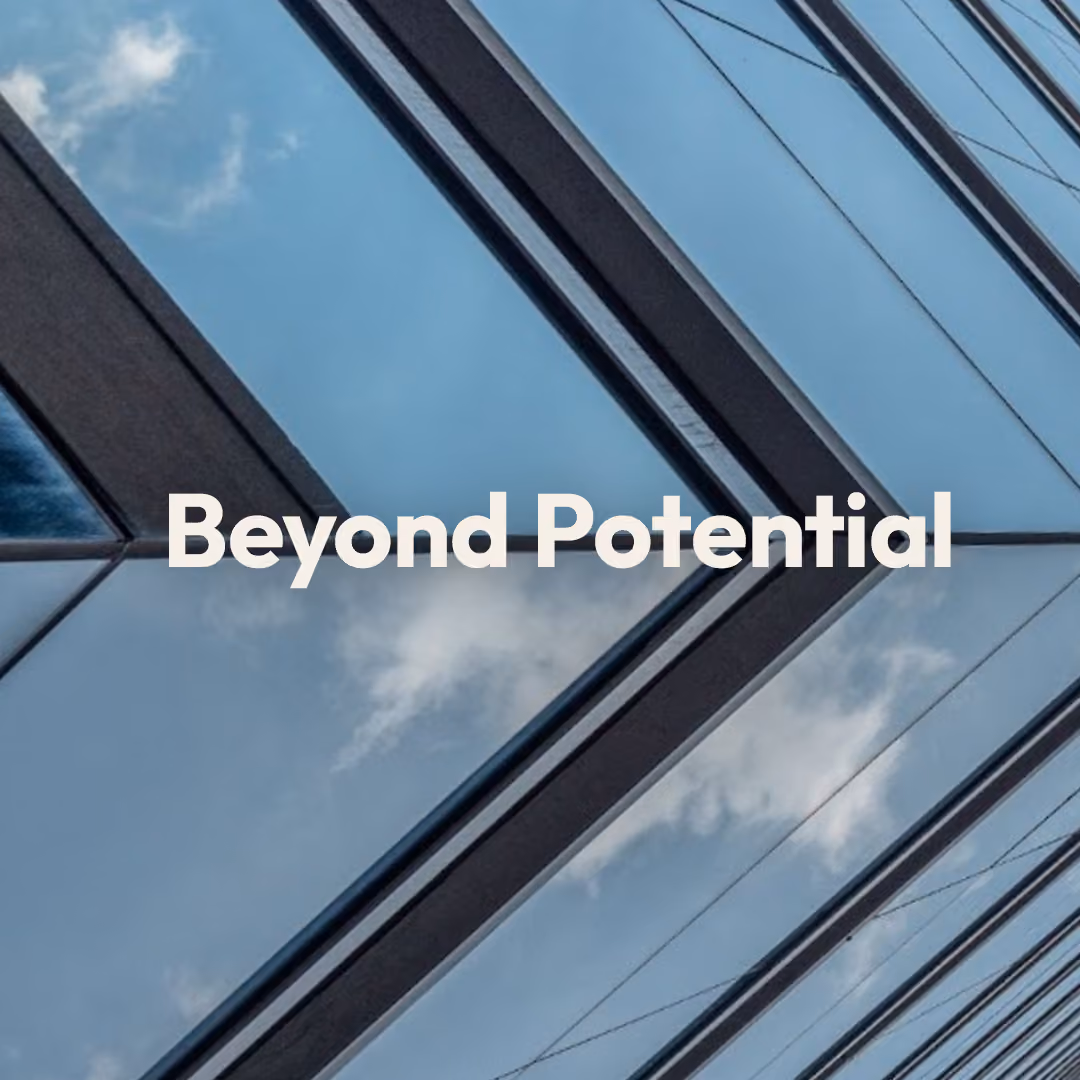 Modern skyscraper with glass windows reflecting the blue sky and clouds, with the words 'Beyond Potential' in bold white letters centred on the image.