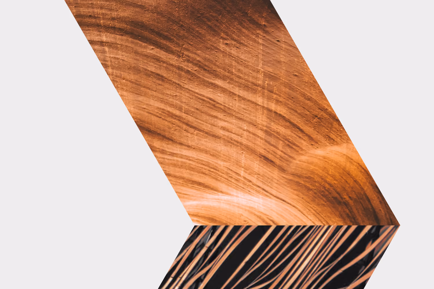 Abstract arrow shape filled with copper-coloured textural imagery that evokes stone and metal.