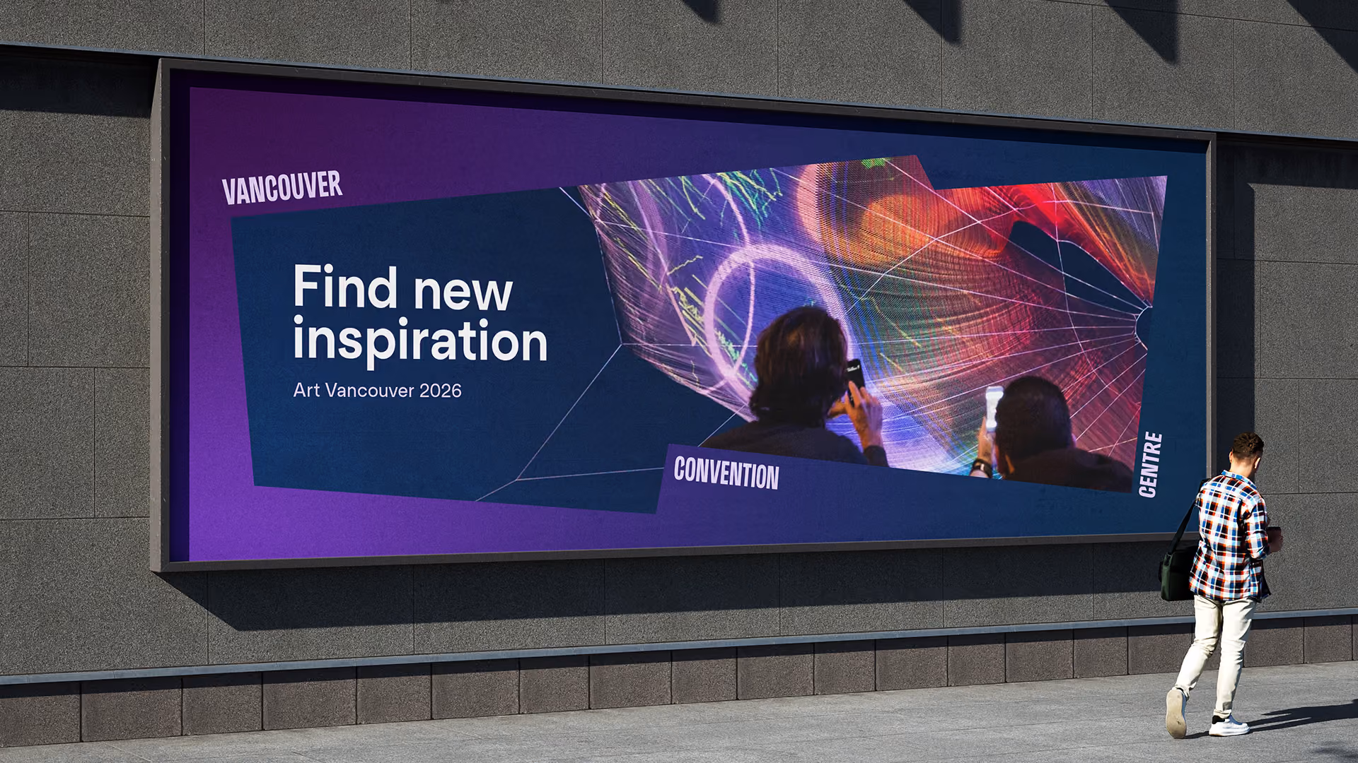 Outdoor billboard on a building wall displaying a purple and blue design with white text that reads 'Find new inspiration Art Vancouver 2026', with words 'Vancouver', 'Convention', and 'Centre' around a colourful image of two people photographing glowing abstract art outdoors.