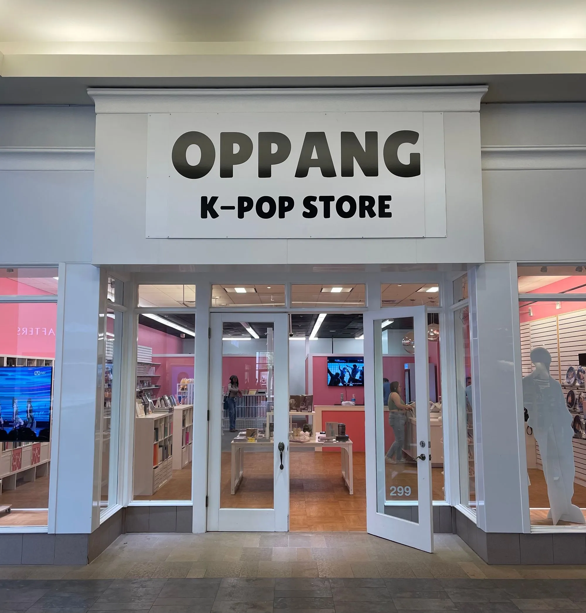 A k - pop store with a large sign above the door