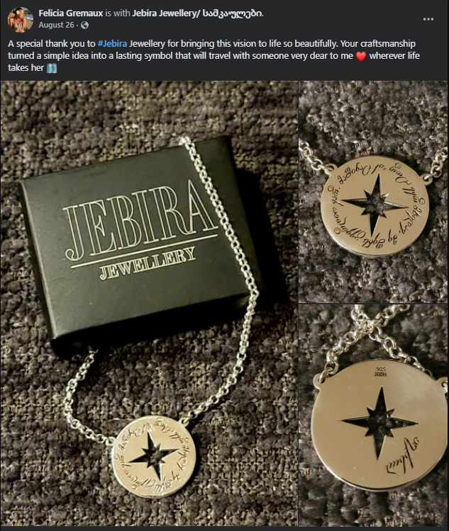 Silver Jebira Jewellery compass pendant necklace with engraved circular design and star-shaped cutout, displayed on a textured dark surface with branded black box.