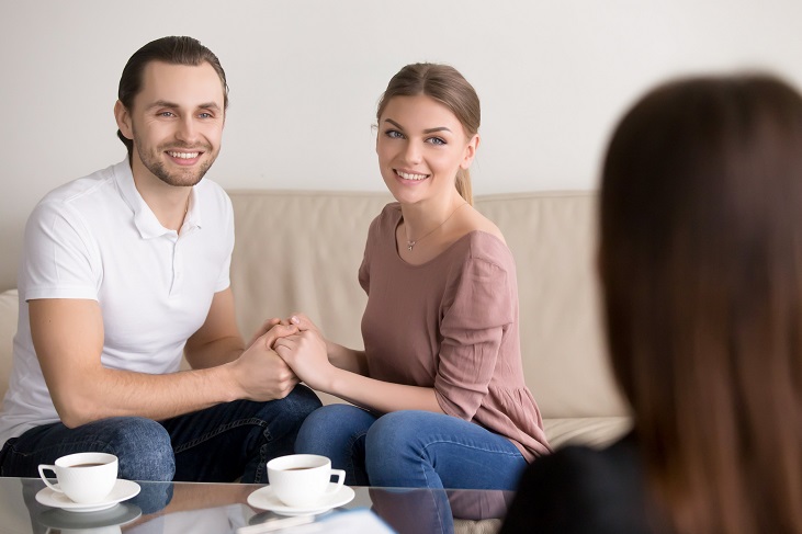 Couple in therapy session with therapist discussing their relationship