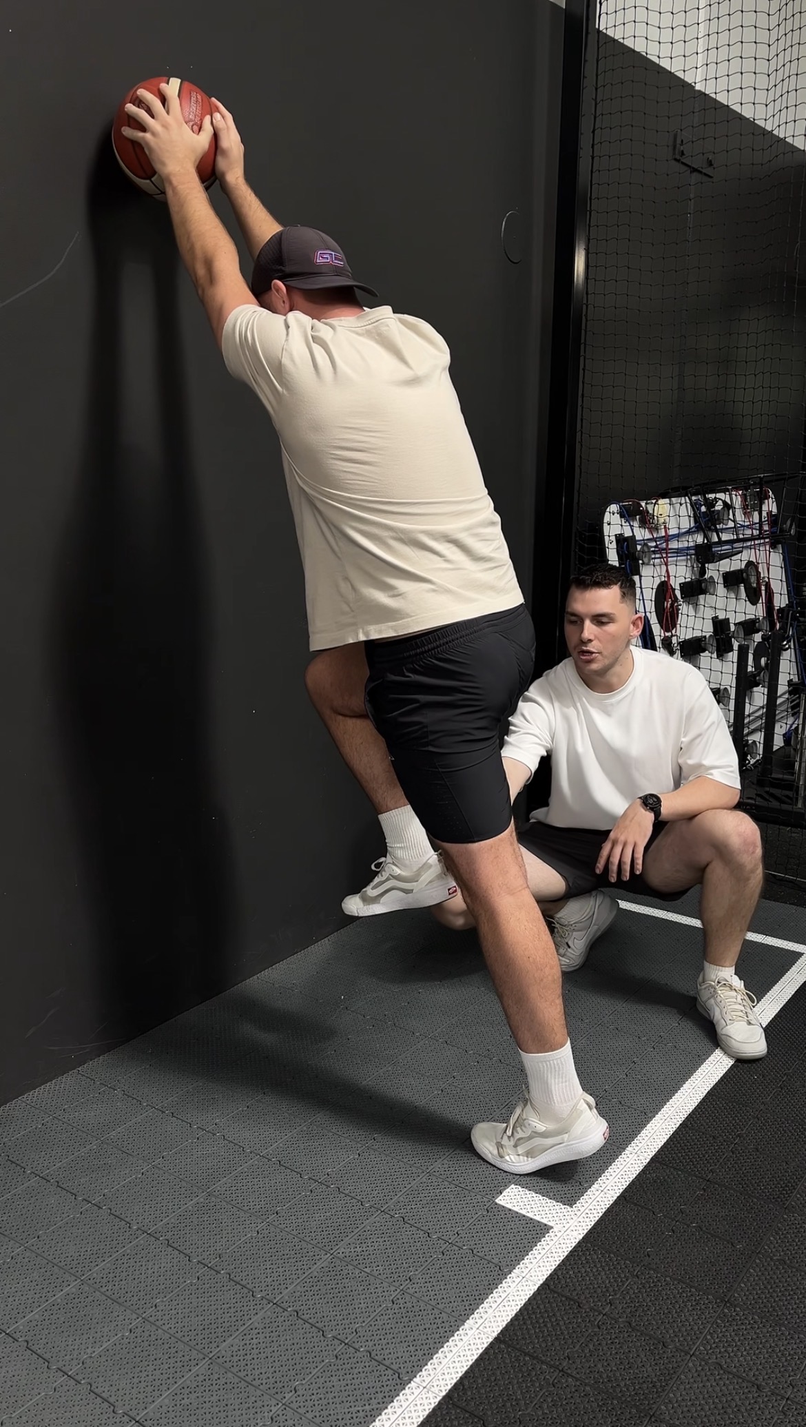 Founder and Head Physio Cody taking a client through a rehab exercise.