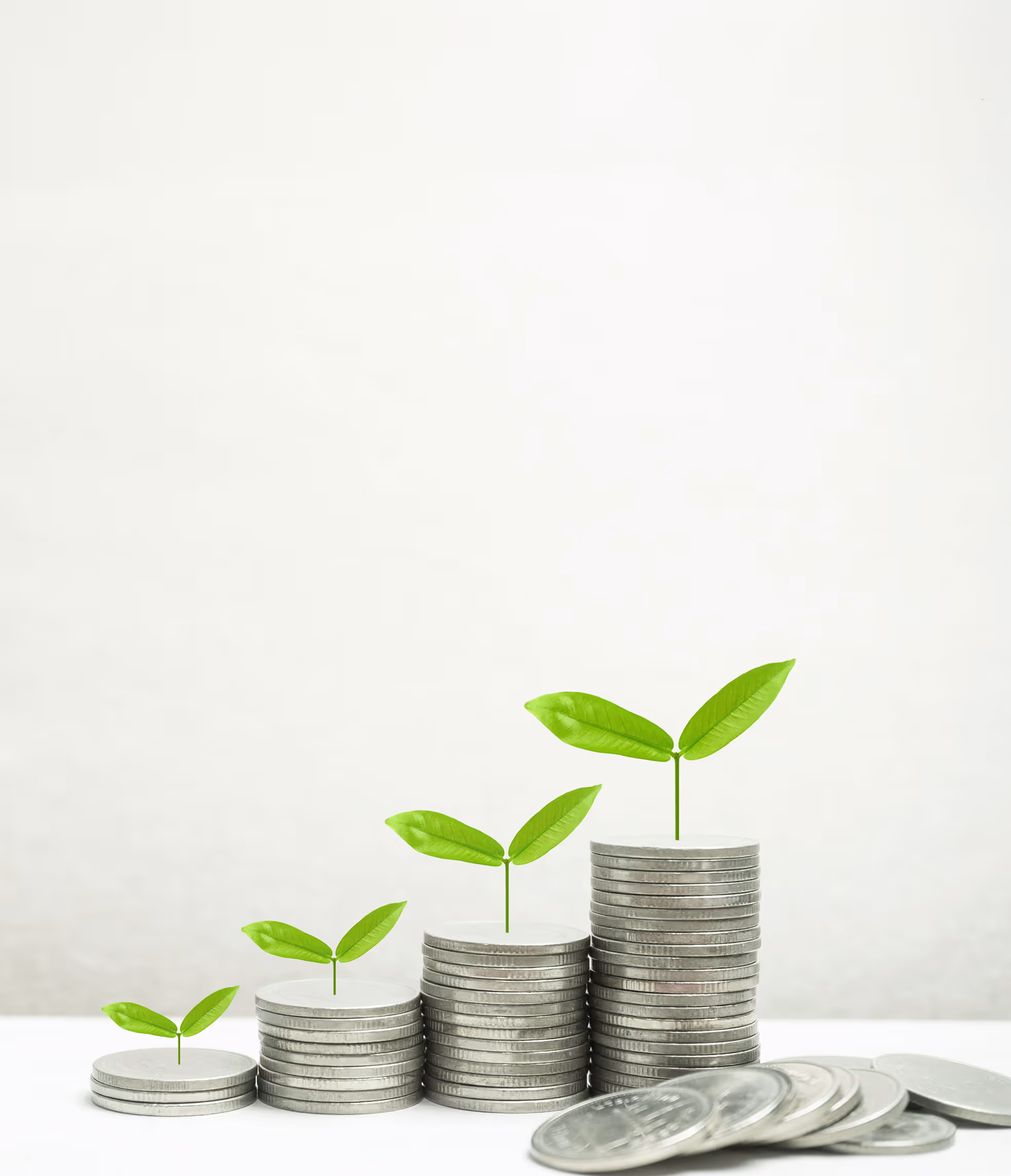 Two people sitting at a table looking at a laptop, one person pointing at the screen.