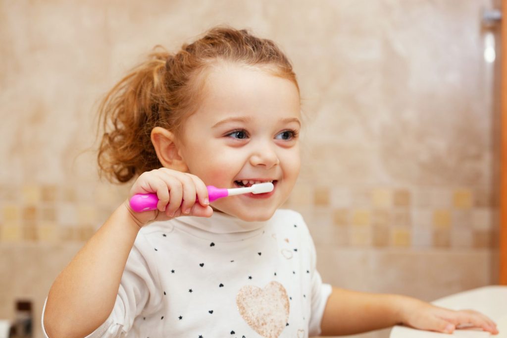 girl kid brushing teeth