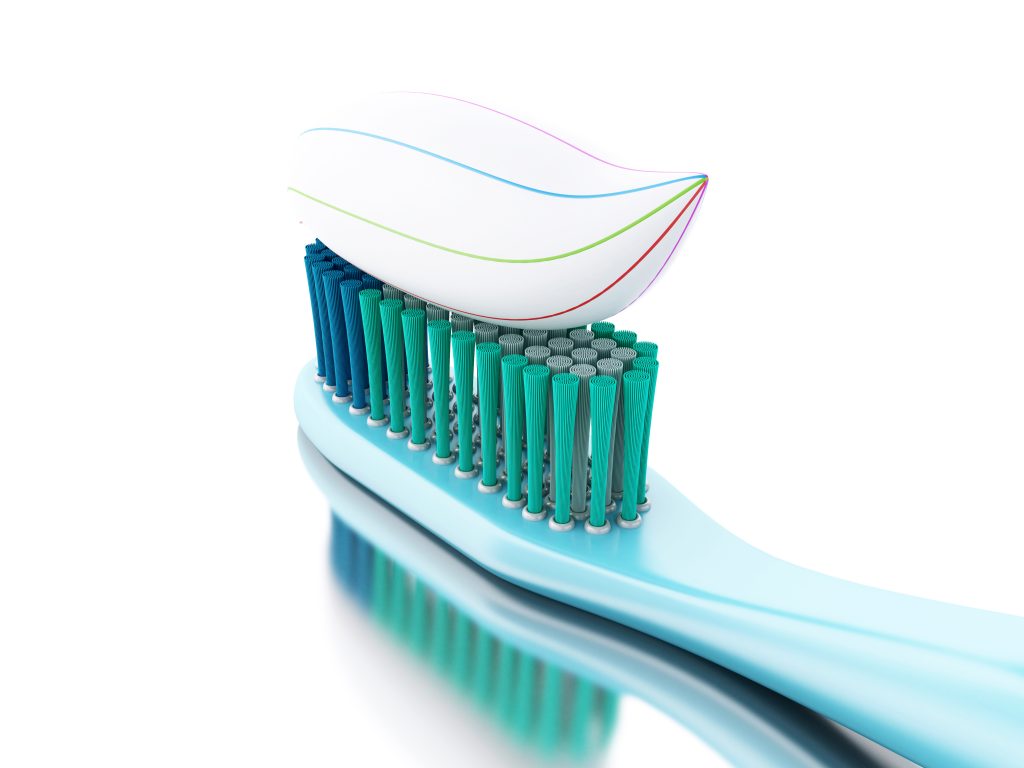 Silicone toothbrush wit h toothpaste on it