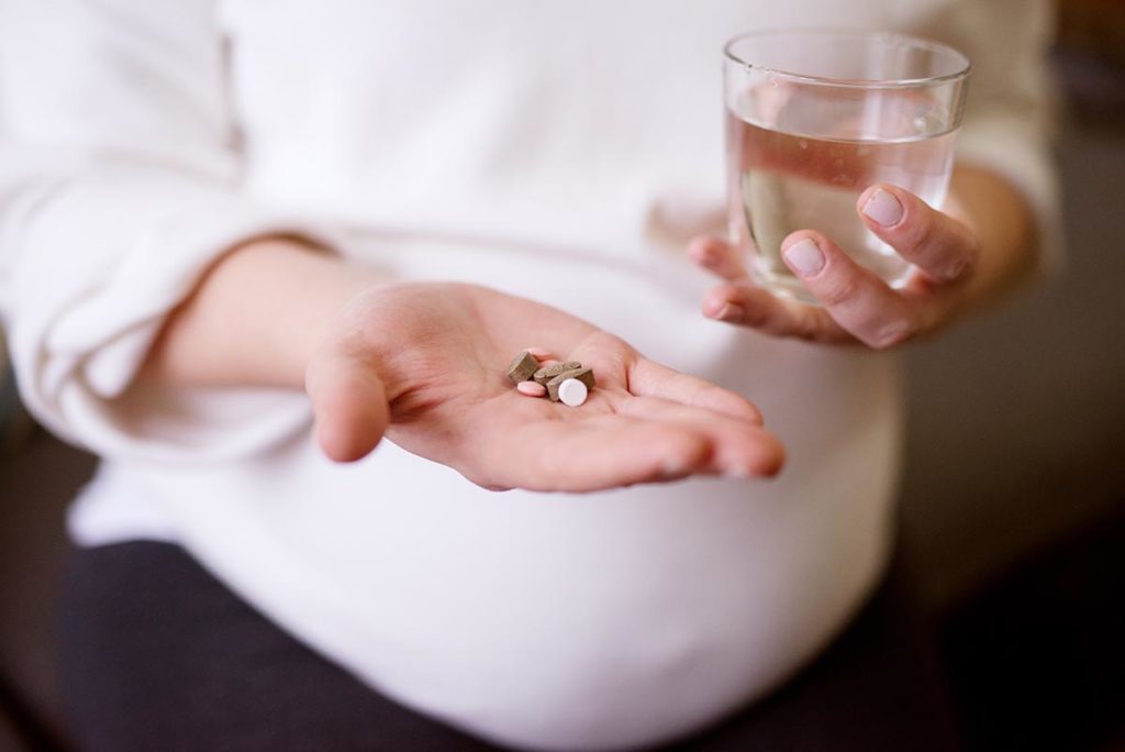 dental-painful-pregnant-woman-hands-holding-medications-dental-blog-dental-dost