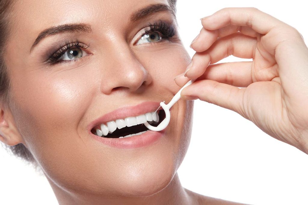 woman-dental-floss-pick-dental-blog
