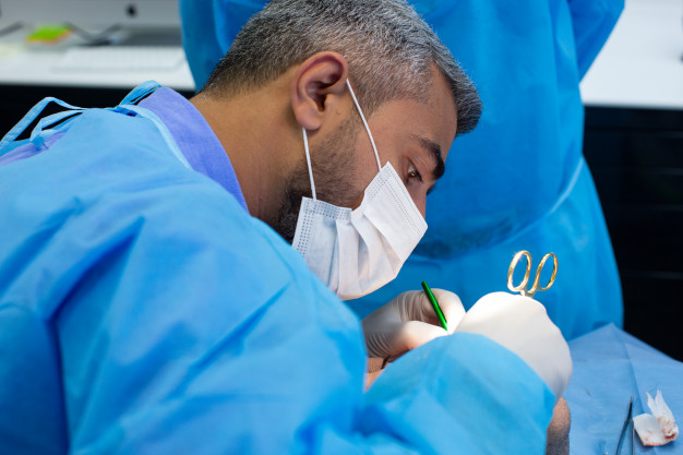 dentist-during-surgery-dental-clinic