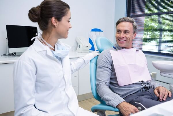 doctor-talking-with-patient-while-sitting-medical-clinic