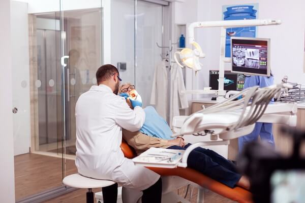 dentist-examining-senior-patient