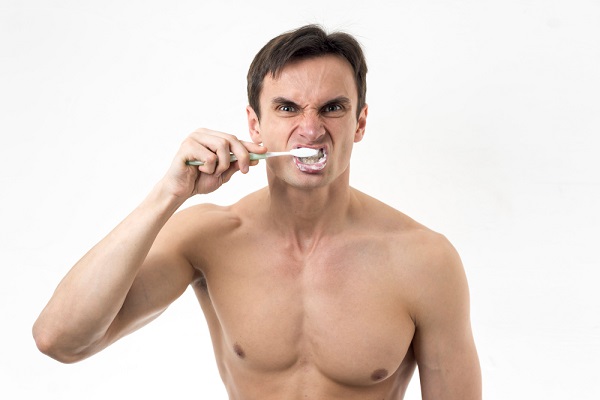 man-furiously-brushing-his-teeth