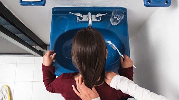 little-girl-rinsing-her-mouth-after-wash-her-teeth-bathroom