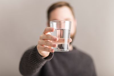 man-showing-glass-water