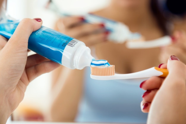 woman-brushing-her-teeth-with-vegan-toothpaste