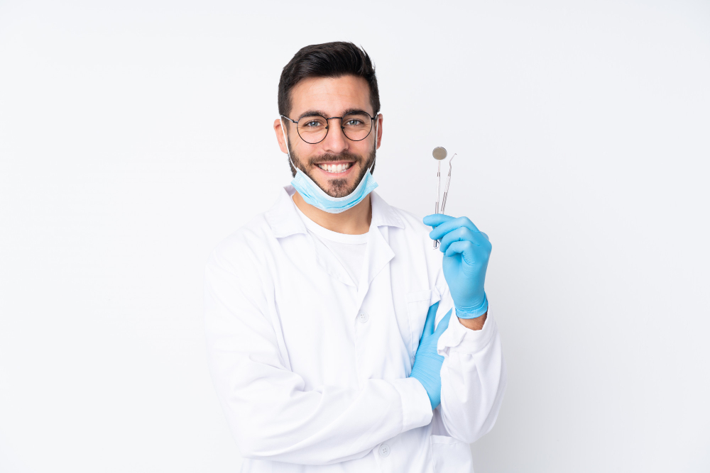 dentist-man-holding-tools-suggesting-Fluoride treatments to avoid future cavities