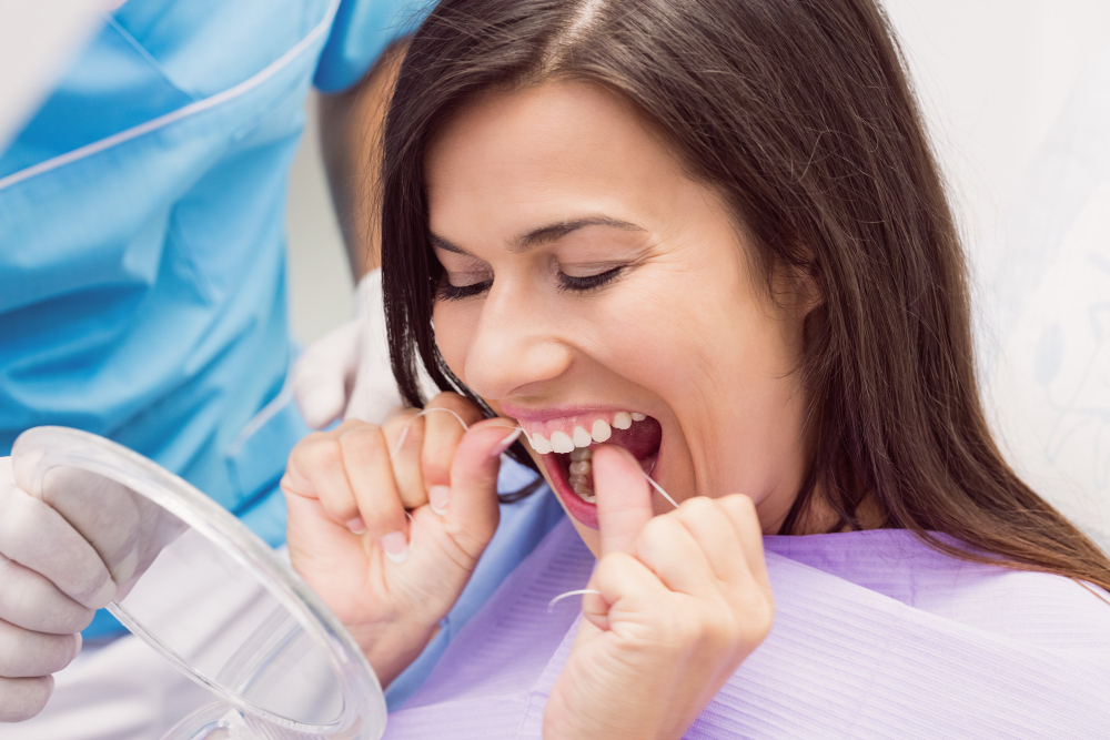 female-patient-flossing-her-teeth