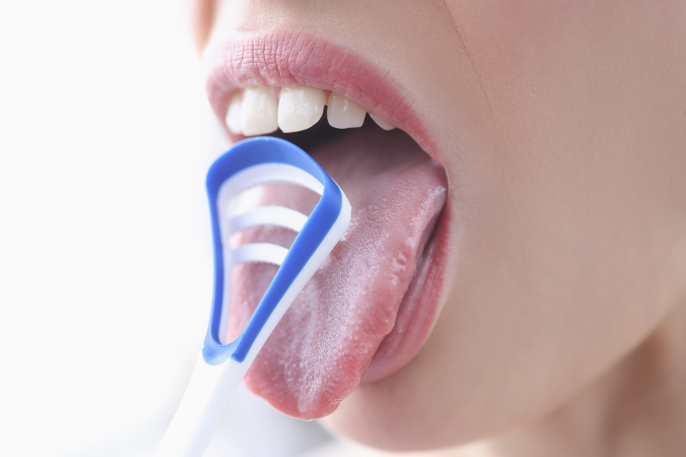 young-woman-cleaning-her-tongue-with-scraper-closeup-oral-hygiene-concept