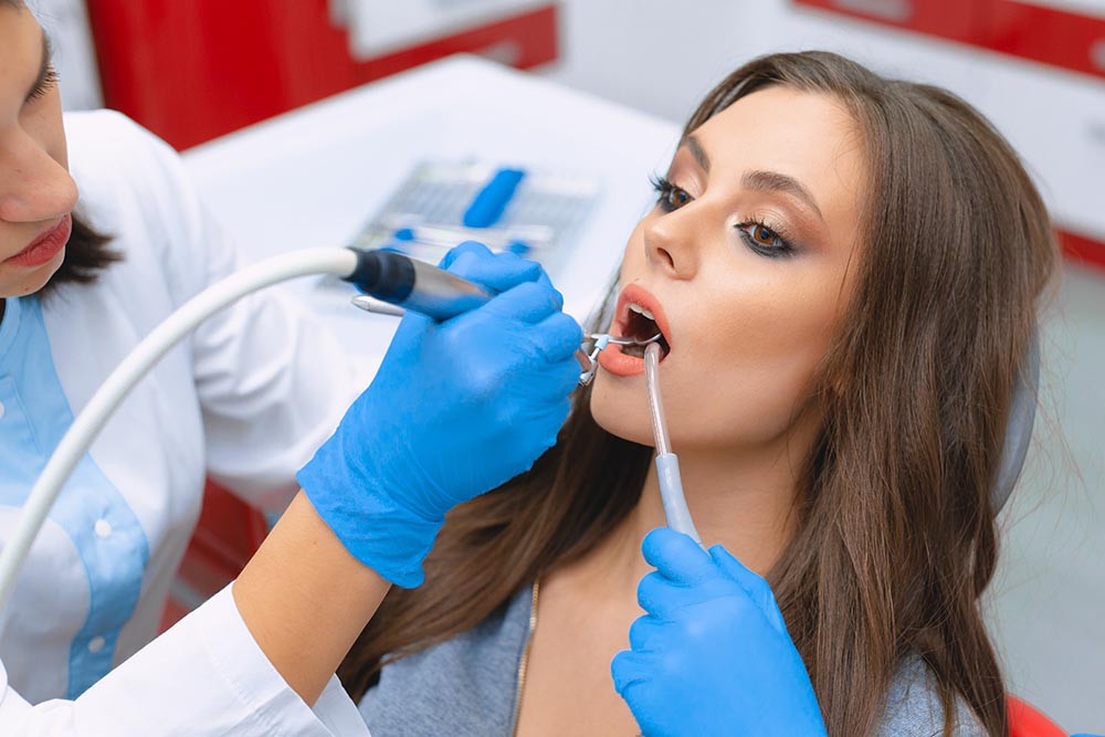 Cleaning and polishing tooth enamel in the dental office.dental-blog-dental-dost