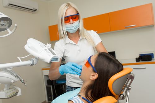 A dentist using laser technology for dental treatment