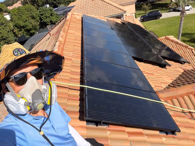 An Orlando home solar panels being cleaned by Pressure Washing Guys