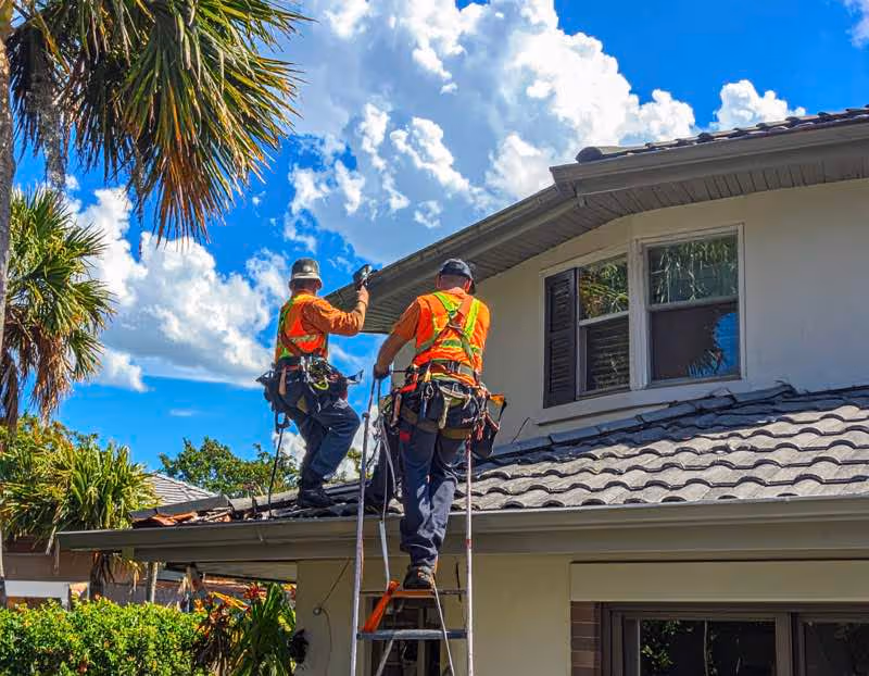A team cleaning Gutters on a residential home in Orlando