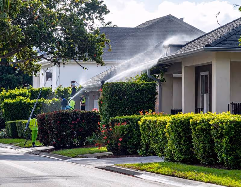 A Orlando home being pressure washed on the gutters