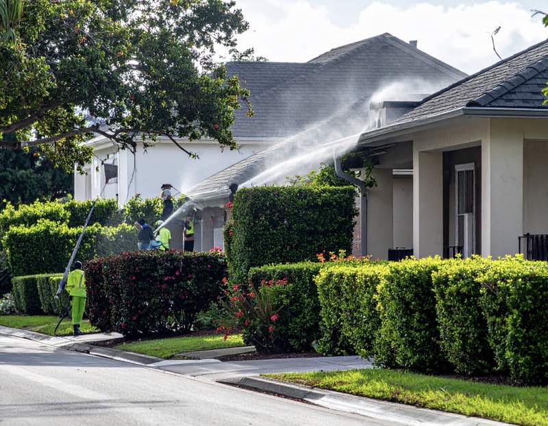 A Orlando home being pressure washed on the gutters