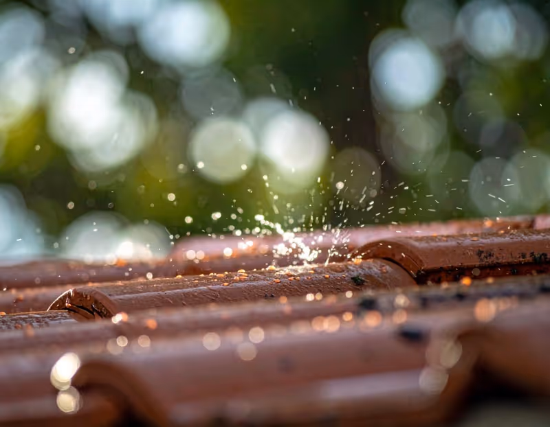 a roof with rain washing down it