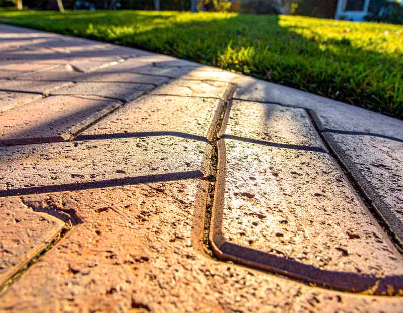 Professional paver sealing service in Orlando FL protecting driveway pavers from sun damage and stains